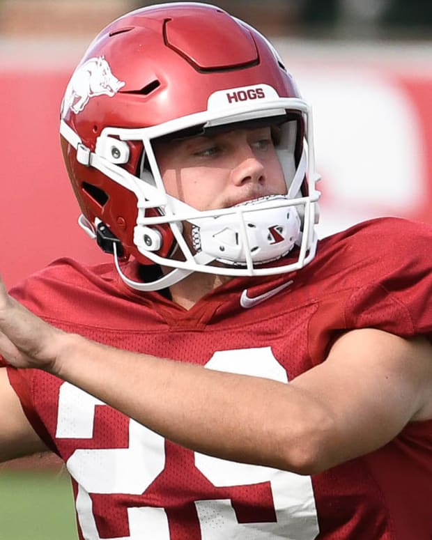 Razorbacks kicker Cam Little throwing the ball during warmups at Sunday morning practice